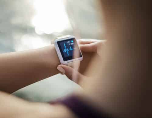 Woman Looking At Her Smart Watch for a pulse trace